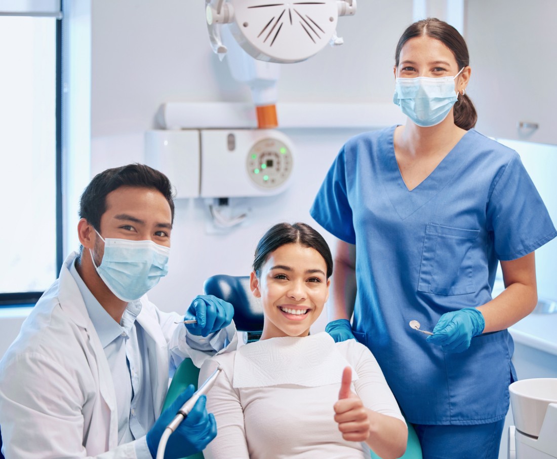 A dentists preparing to clean a patient's teeth